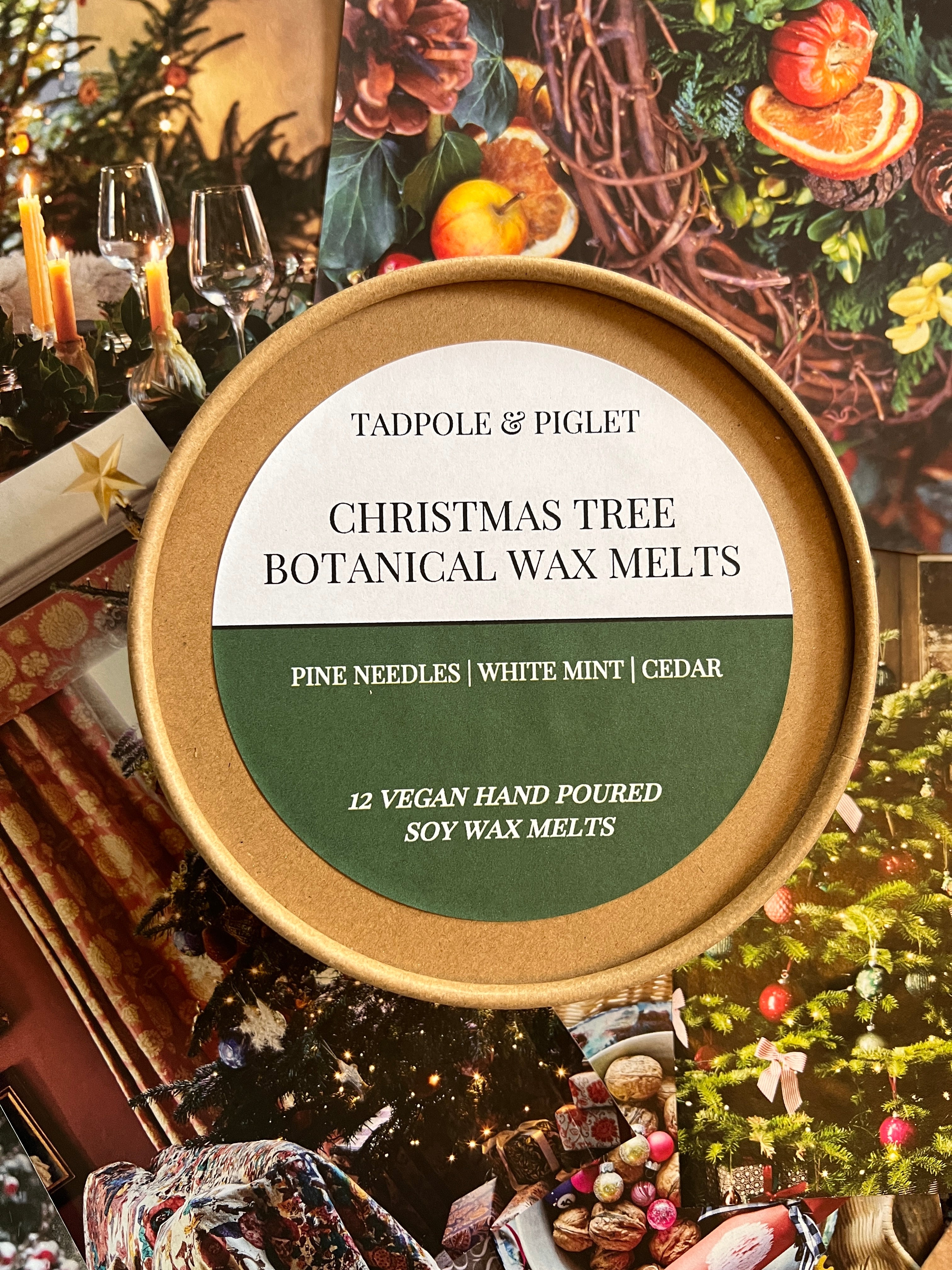 Tadpole & Piglet Christmas Tree Botanical Wax Melts tin featuring pine needles and cedar scent, surrounded by festive decor.