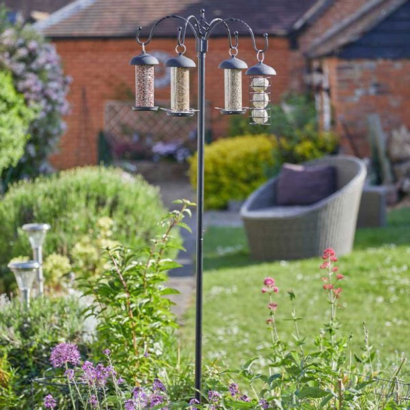 A four-feeder wild bird feeding station