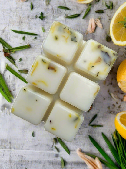 Lemon Verbena Botanical Wax Melt Bar with floral accents on a background of blooming cherry blossoms.