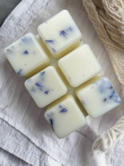 Fresh Linen Botanical Wax Melt Bar cubes with floral accents against a floral background, perfect for wax burners.