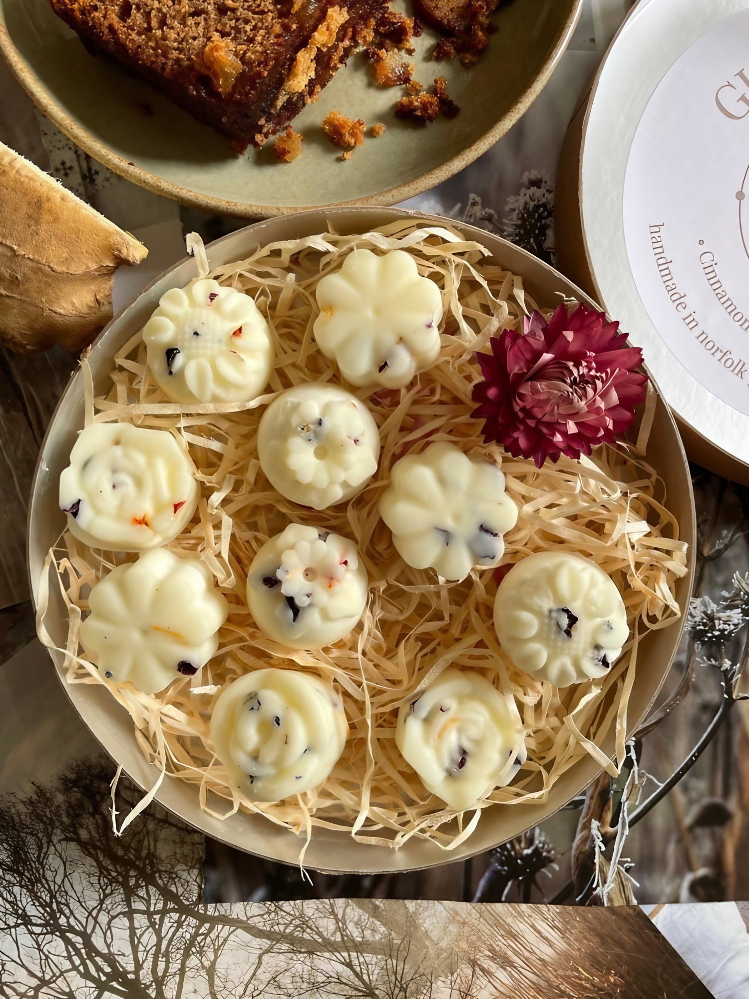 Gingerbread wax melts arranged in a decorative bowl with natural elements, perfect for creating a cozy atmosphere.
