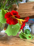 Nasturtium Tom Thumb flowers arranged in a vase with foliage
