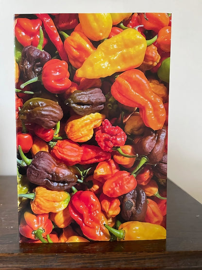 Greeting card featuring a vibrant design of assorted chili peppers in various colors.