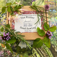 The Winter Seed Sowing Flower Box by Bishy Barnabees Cottage Garden sits among fresh flowers and greenery on vibrant garden-themed backgrounds—ideal for winter seed sowing and effective stratification.