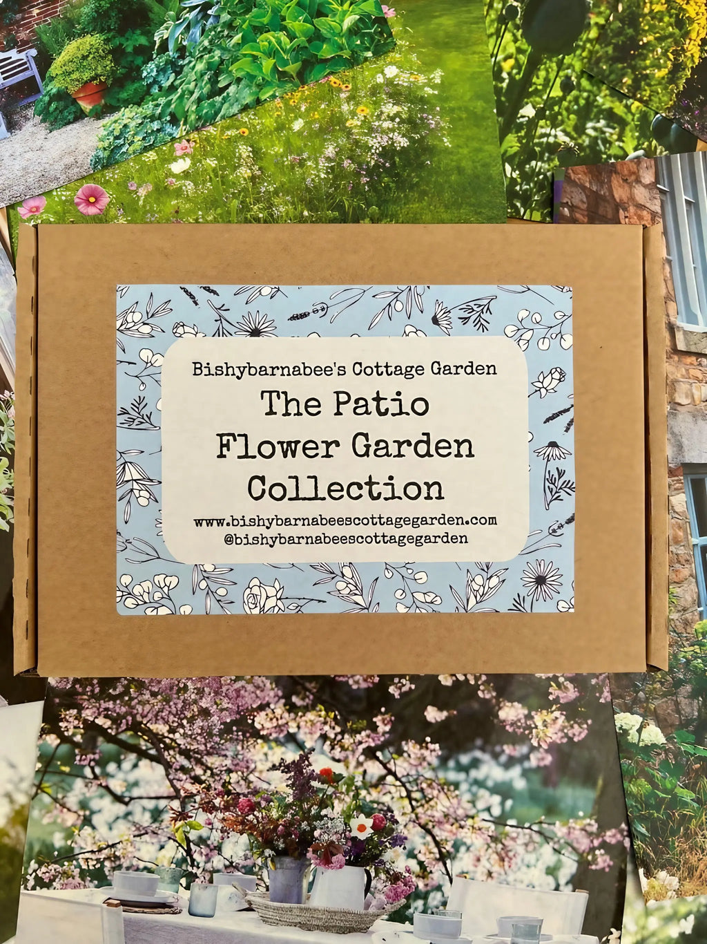 A cardboard box labeled The Patio Flower Garden Collection by Bishy Barnabees Cottage Garden, ideal for container flower seeds, is surrounded by colorful garden and flower photos.