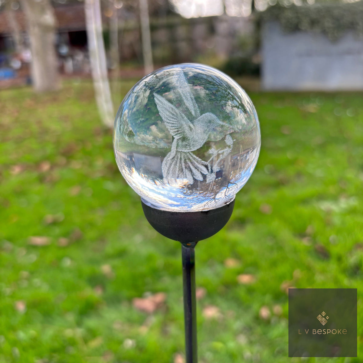 3D orb garden stake with an etched hummingbird and flowers