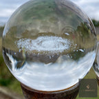 Close-up of a 3D orb garden stake with a laser-etched spiral galaxy inside the crystal sphere