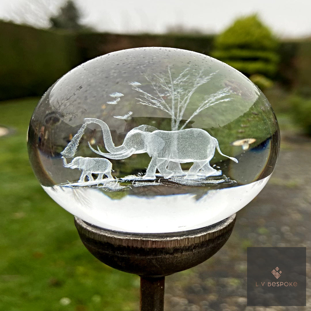 3D orb with a laser-etched elephant family beneath a tree