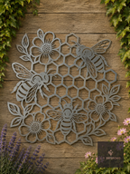 Metal honeycomb wall art with bees and flowers on a wooden fence