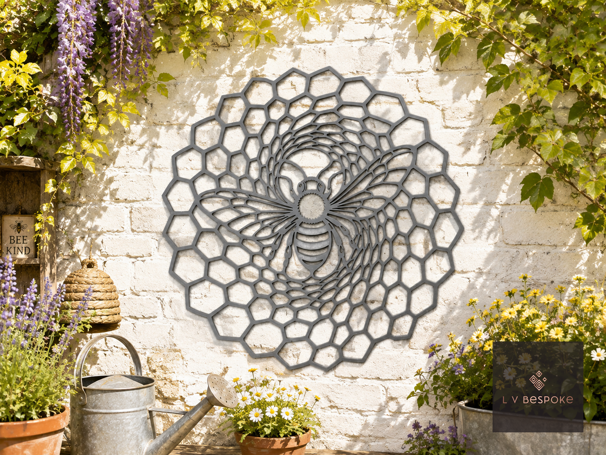 Round metal bee and honeycomb wall plaque on a white brick garden wall