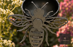 Metal garden stake with a small cup and bee cut-out