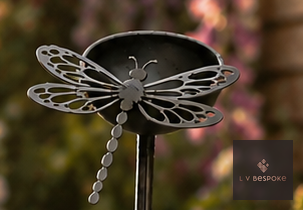 Metal garden stake with a small cup and dragonfly cut-out