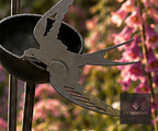 Metal garden stake with a small cup and swallow cut-out