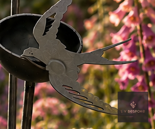 Metal garden stake with a small cup and swallow cut-out