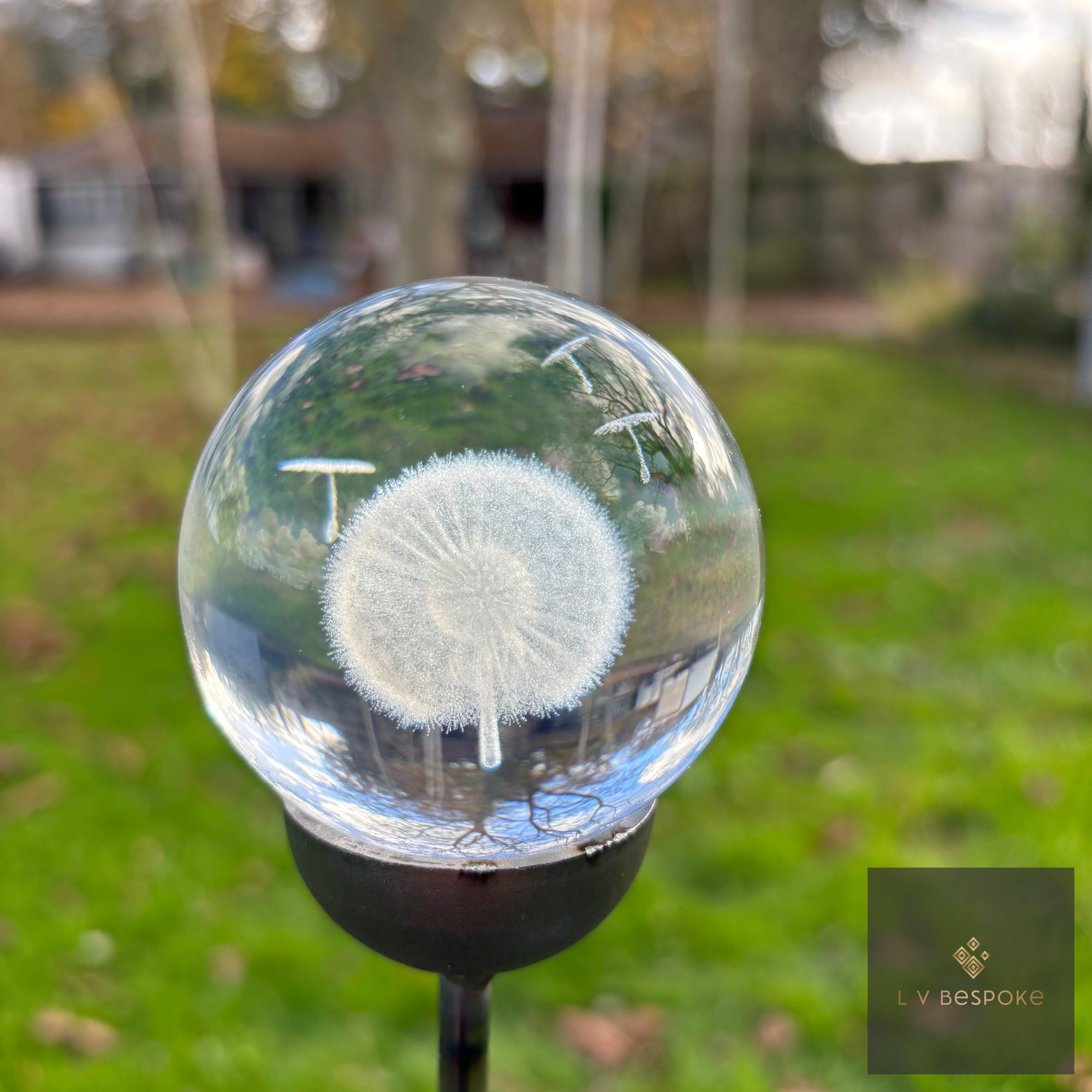 Close-up of the 3D laser-etched bee design inside the crystal orb