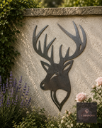 Metal stag head wall art on a rendered garden wall