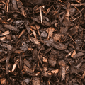 A close-up of Dandy's Topsoil & Landscape Supplies Landscaping Garden Bark Mulch, featuring dark brown, moist wood and bark pieces in varied textures with scattered thin sticks.