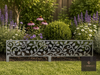 Decorative metal leaf-pattern lawn edging in front of a flower border