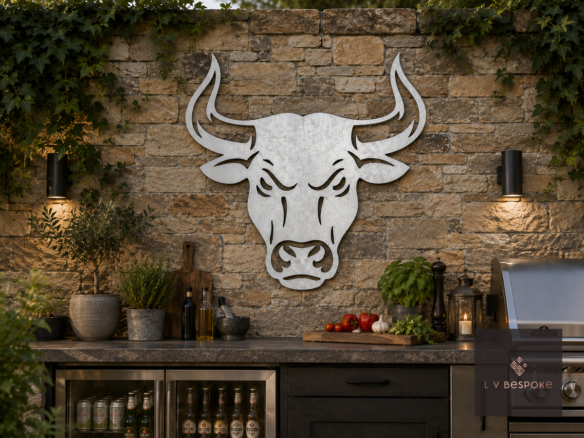Metal bull head wall art on a stone wall in an outdoor kitchen