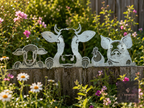 Metal farm animals wall art of a cow, sheep and pig on a fence