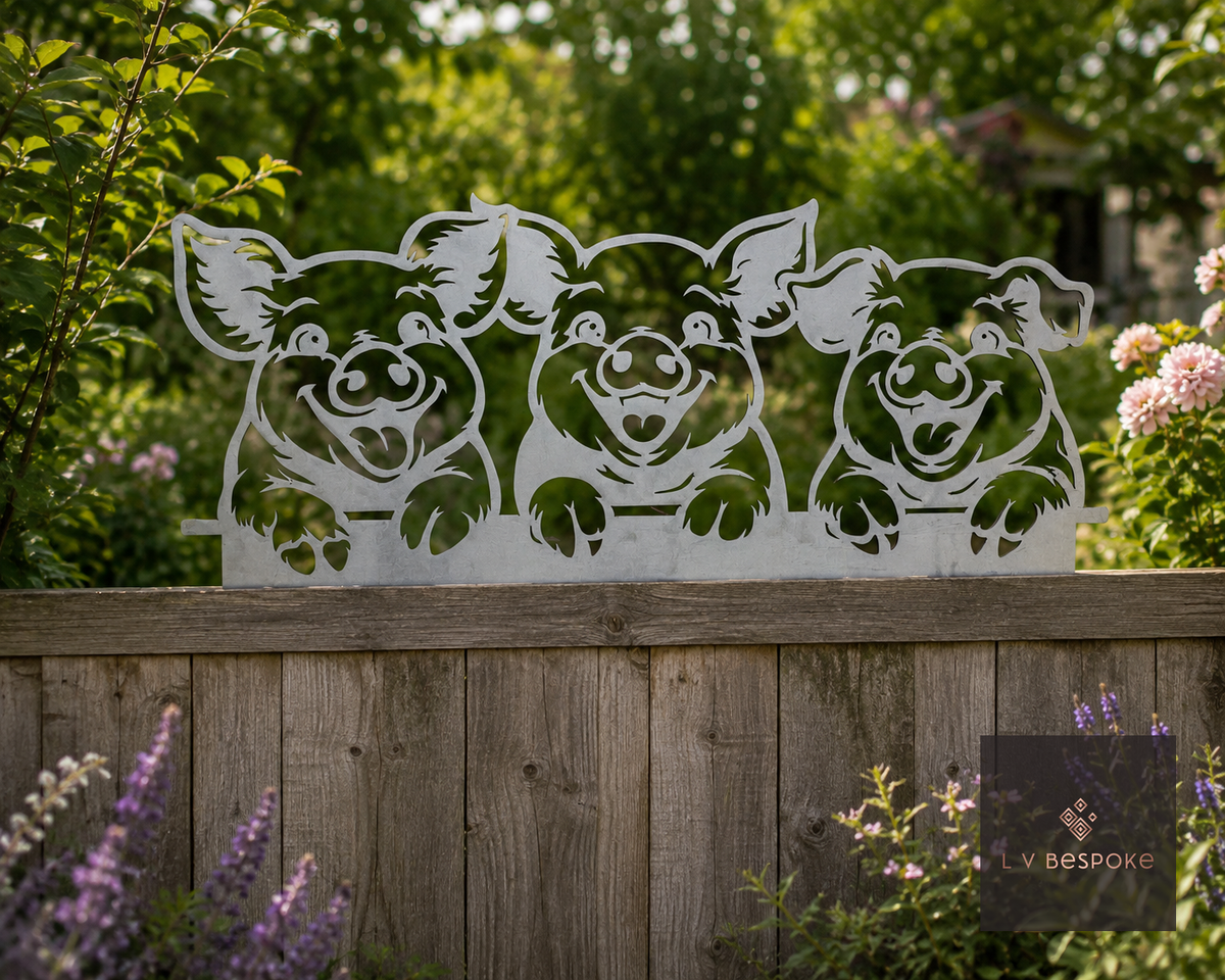 Metal three pigs wall art on a wooden fence behind flowers