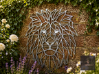 Geometric metal lion head wall art on a stone wall
