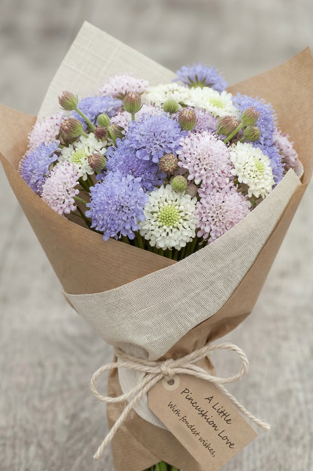 Didiscus Madonna Mixed – bouquet of lilac, white and pink flowers wrapped in brown paper