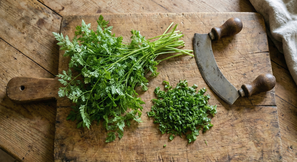 Fresh green herbs on a wooden cutting board with a knife