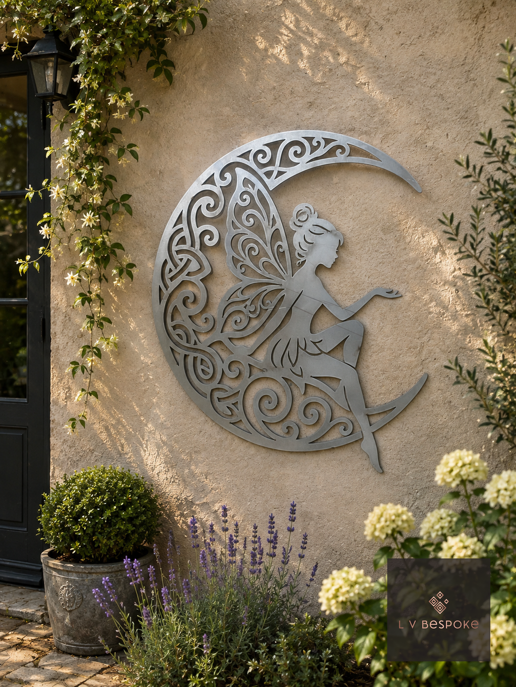 Metal fairy on a crescent moon wall art on a rendered wall