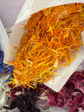 A bag of natural orange dried flower petals from Bishy Barnabees.
