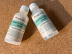 Two bottles of Horticultural Soap by ladybirdplantcare.co.uk rest on a cork surface. Each features a white cap and green label showing "Dilution Rate 1:100" along with product information.