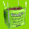 A large green Dandy's Topsoil & Landscape Supplies bulk bag of Landscaping Garden Bark Mulch is displayed against a bright green background, with the bag also listing turf, topsoil, gravel, compost, and company contact details.