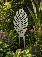 Metal leaf garden stake among echinacea and hostas