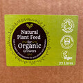 A green label on brown, recyclable packaging reads Natural Plant Feed 22L "Bag in a Box" by Natural Grower, featuring Soil Association Approved, Biodegradable, and Vegan logos. This organic slow-release feed comes in a 22-litre volume.