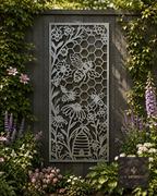 Metal bee and honeycomb garden screen panel among flowers