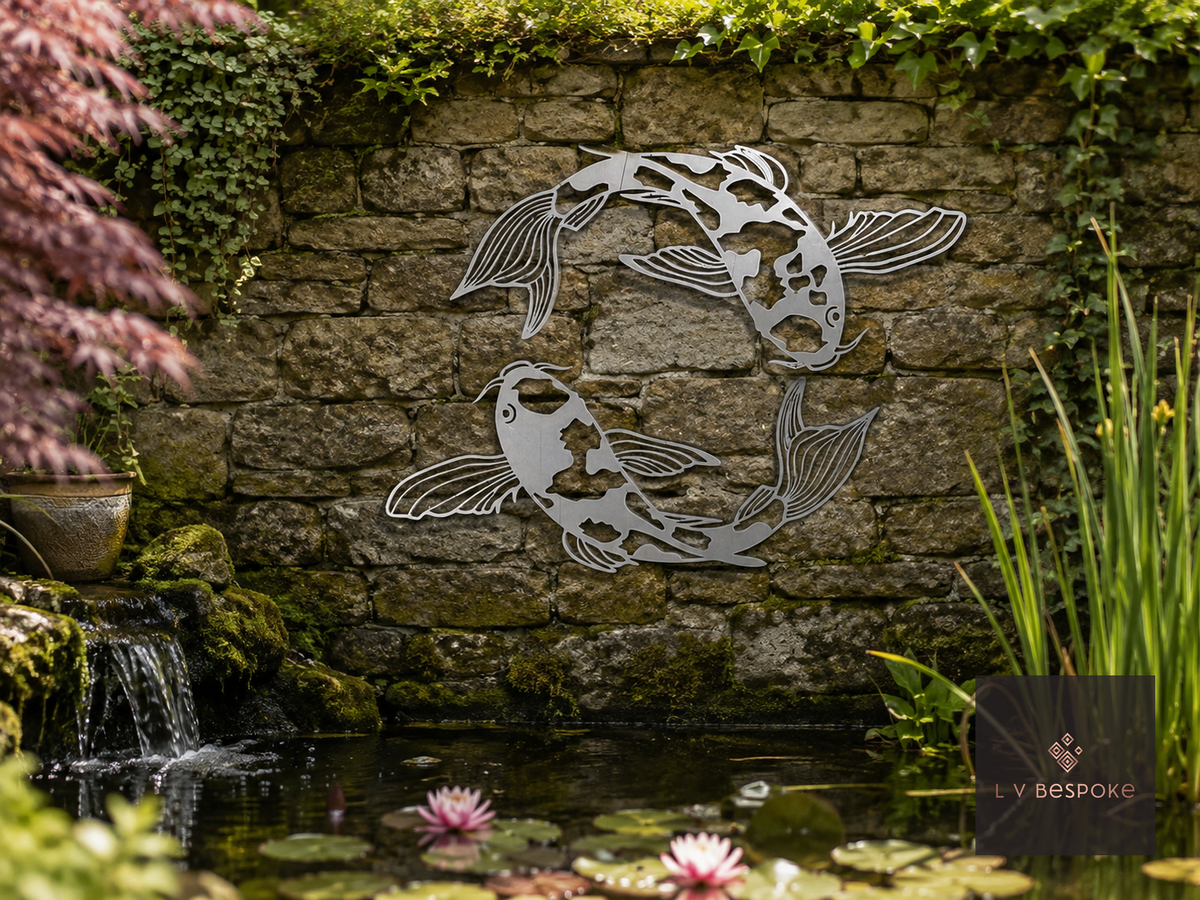 Metal koi fish wall art on a stone wall above a pond