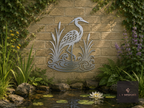 Metal heron wall art on a garden wall