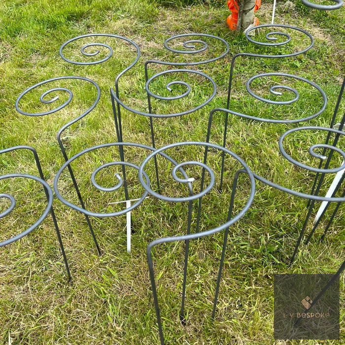 Pig Tail Plant Supports – group of spiral-topped metal supports on a lawn