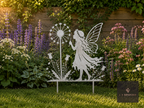 Metal fairy with dandelion clock garden stake on a lawn