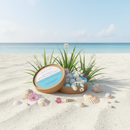 A round box of Tadpole & Piglet Seychelles Botanical Wax Melts sits open on a sandy beach with green grass and white flowers nearby, while the ocean sparkles—hinting at soothing coconut and vanilla fragrance.