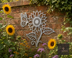Metal sunflower and butterfly wall art beside sunflowers
