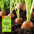 A close-up of carrots growing in soil with a bag of Dandy's Topsoil & Landscape Supplies Topsoil Welsh VegeGrow® for vegetables in the foreground. The peat-free bag highlights its suitability for cultivating vegetables and herbs.