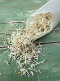 A bag of natural white dried flower petals from Bishy Barnabees.