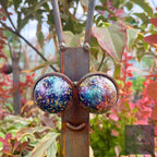 Close-up of a snail stake face with large glittery blue marble eyes and a smile