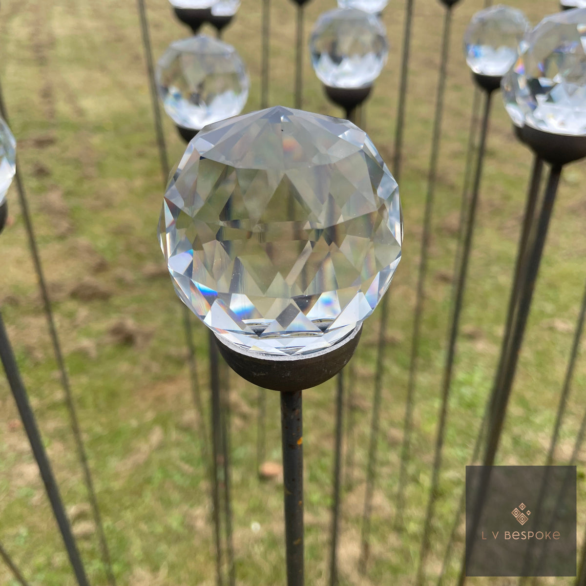 Faceted 60mm glass prism on a steel stake in a lawn
