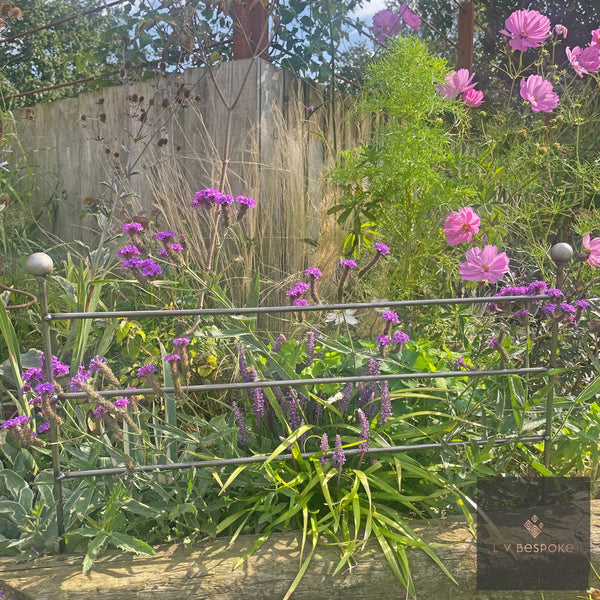 Victorian style raw steel border edging in front of verbena and phlox