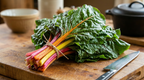 Chard Rainbow Mixed (Beta vulgaris) – bunch of red, yellow and pink stems on a board beside a chef's knife