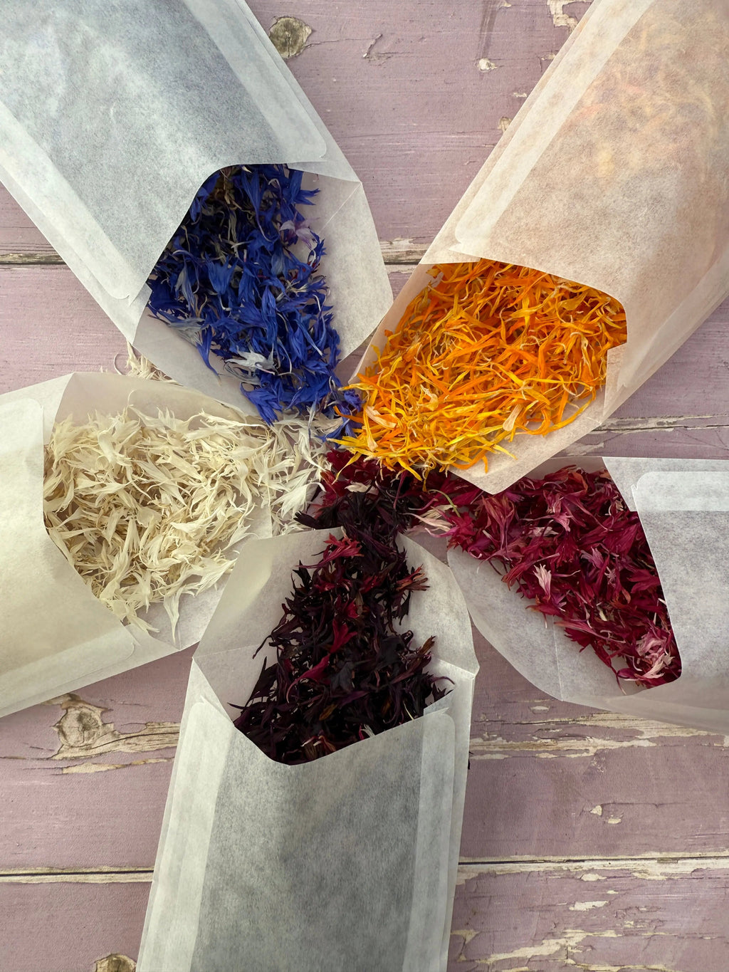 Dried Flower Petals – open bags of blue, orange, white, burgundy and red petals