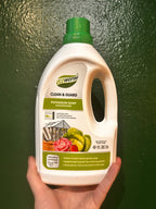 Ecoworm Potassium Soap – hand holding the 1 litre concentrate bottle with green cap