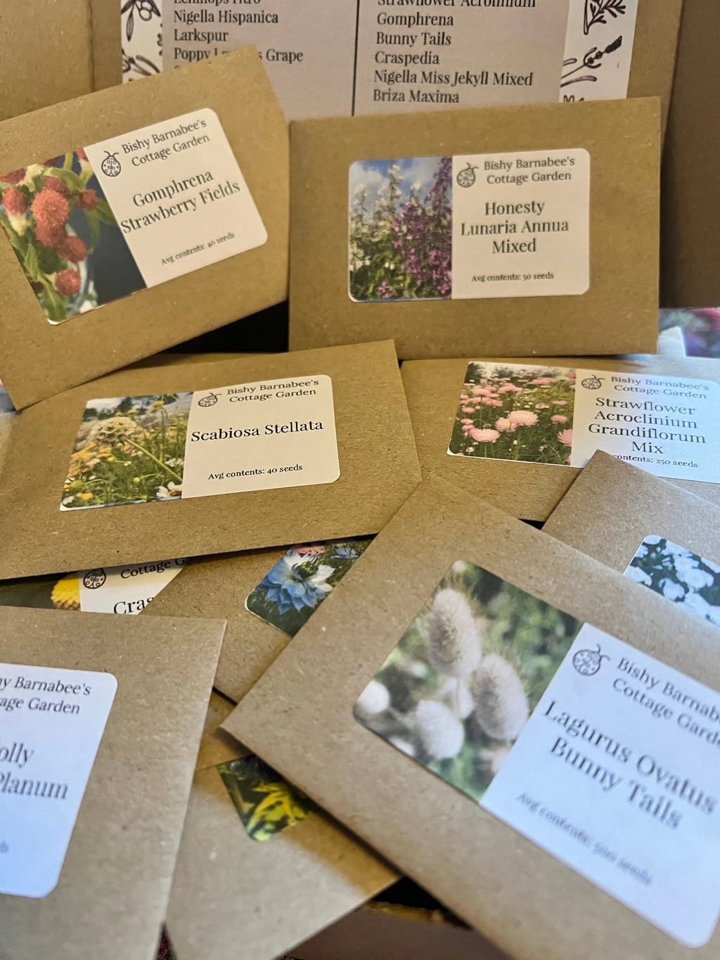 Bishy Barnabees Cottage Garden’s "Flowers Perfect for Drying Extra" features brown seed packets with colorful flower images and a printed list of varieties—ideal dried flower seeds for creating everlasting bouquets.